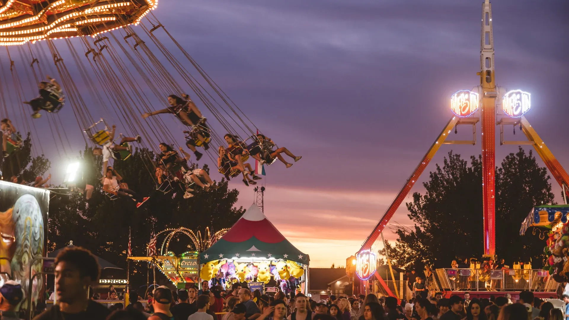 Family enjoying rides at Fox Creek Amusements carnival